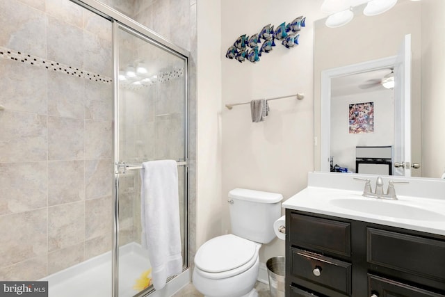 bathroom featuring toilet, vanity, and walk in shower