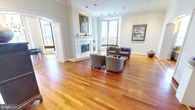 living room featuring light hardwood / wood-style flooring and ornamental molding