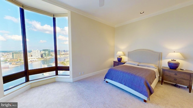 bedroom featuring crown molding, a water view, light colored carpet, and ceiling fan