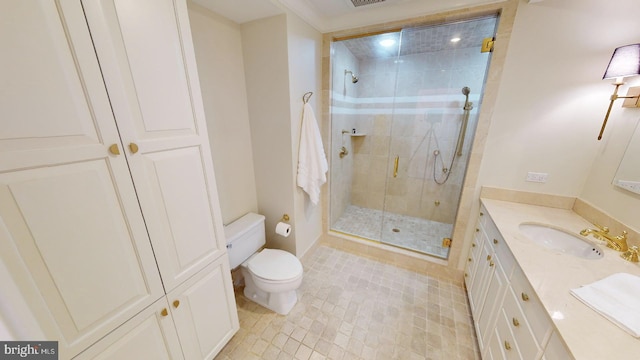 bathroom featuring vanity, an enclosed shower, and toilet