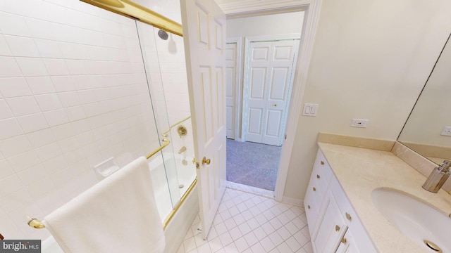 bathroom with enclosed tub / shower combo, vanity, and tile patterned flooring