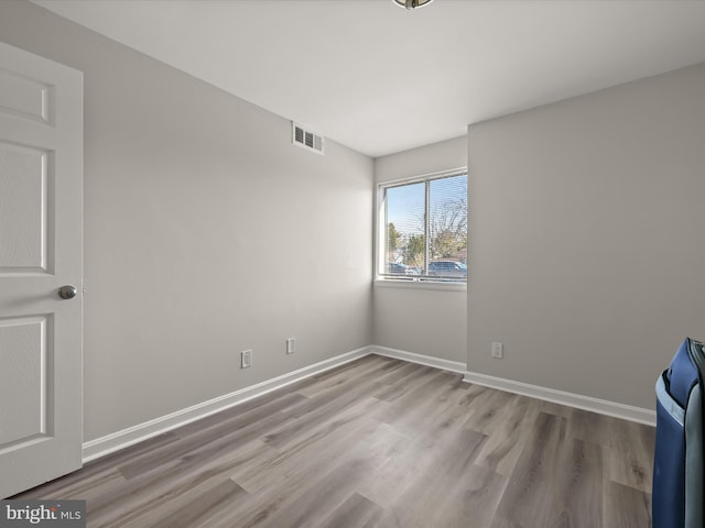 unfurnished room with light wood-type flooring