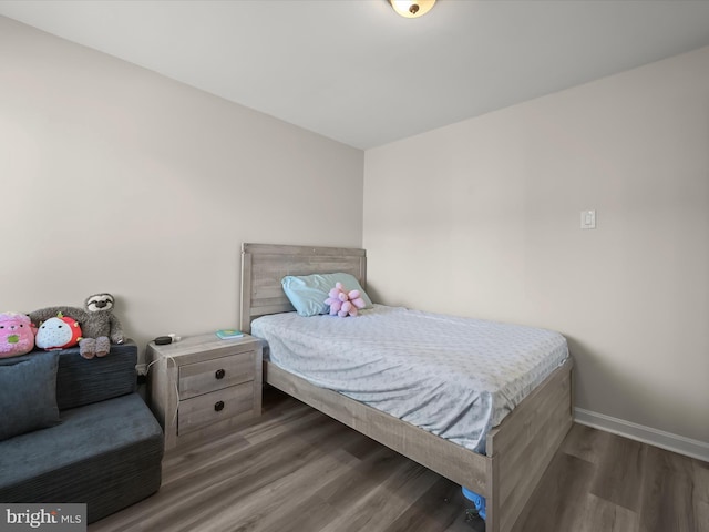 bedroom with dark wood-type flooring