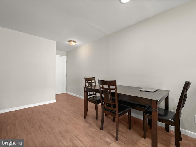 dining space featuring light wood-type flooring