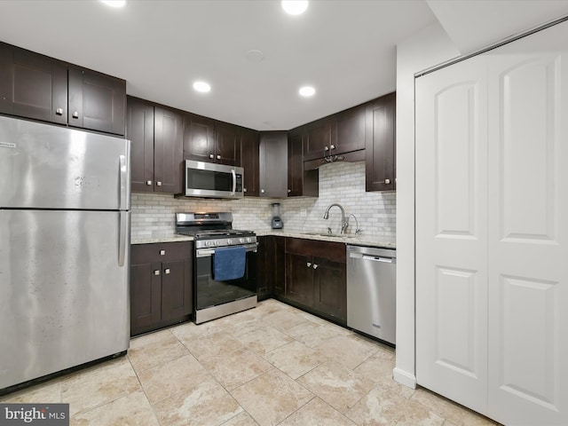 kitchen with dark brown cabinetry, sink, tasteful backsplash, and stainless steel appliances