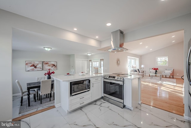 kitchen featuring stainless steel electric range oven, black microwave, kitchen peninsula, island exhaust hood, and white cabinets