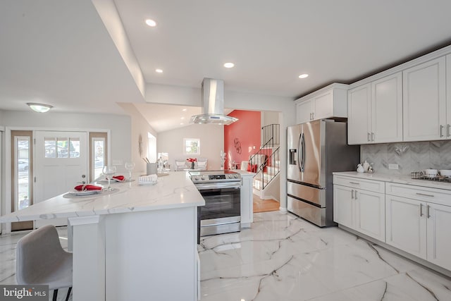 kitchen with a breakfast bar area, backsplash, stainless steel appliances, island exhaust hood, and a kitchen island