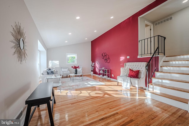 living room with lofted ceiling and hardwood / wood-style floors