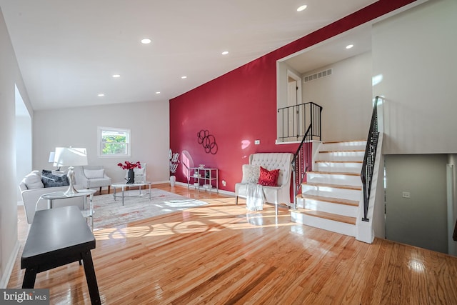 living room with lofted ceiling and hardwood / wood-style floors