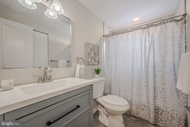 bathroom with vanity, tile patterned flooring, and toilet