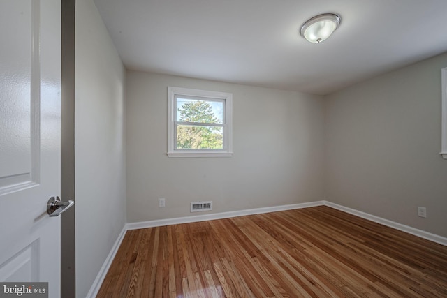 spare room featuring wood-type flooring