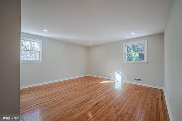 spare room featuring light hardwood / wood-style floors