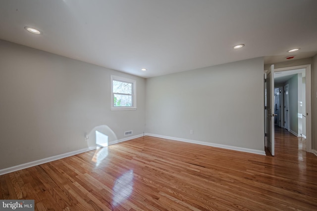 spare room with wood-type flooring