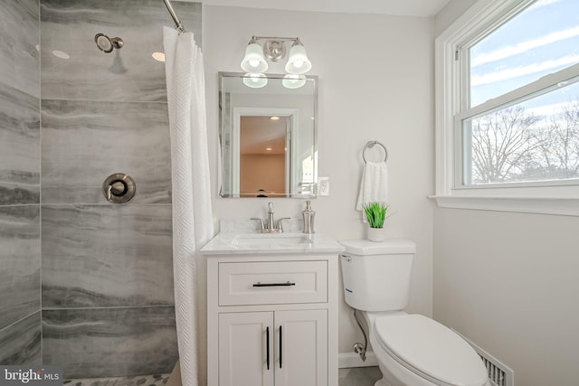 bathroom featuring walk in shower, vanity, and toilet