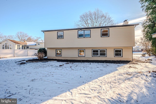 view of snow covered rear of property