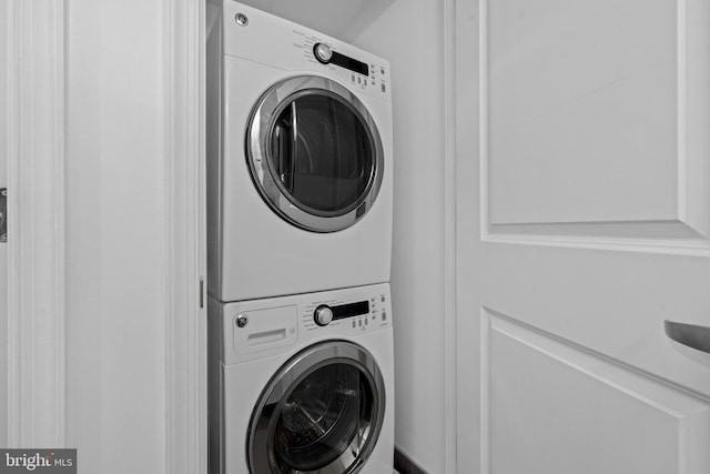 laundry area with stacked washer and clothes dryer