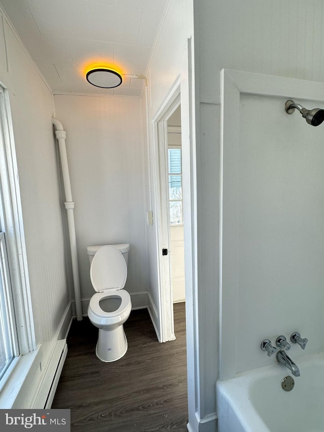 212 Logan St, Lewistown, PA 17044 - bathroom featuring a bath, hardwood / wood-style flooring, a baseboard radiator, and toilet