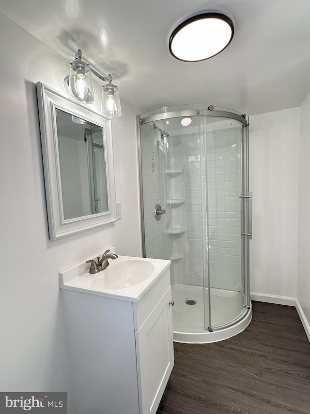 212 Logan St, Lewistown, PA 17044 - bathroom featuring an enclosed shower, hardwood / wood-style floors, and vanity