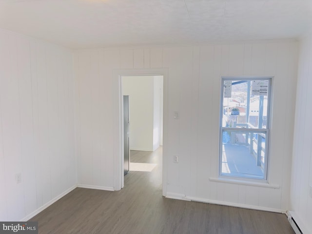212 Logan St, Lewistown, PA 17044 - unfurnished room with plenty of natural light, dark hardwood / wood-style flooring, and a baseboard heating unit