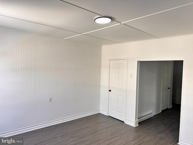 212 Logan St, Lewistown, PA 17044 - empty room with a baseboard heating unit and dark wood-type flooring