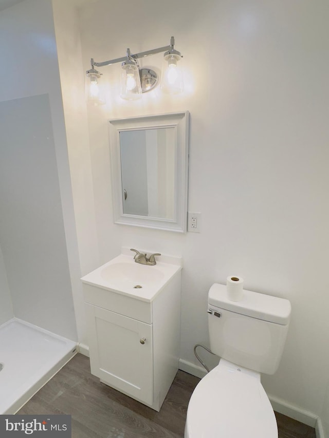 212 Logan St, Lewistown, PA 17044 - bathroom featuring vanity, hardwood / wood-style floors, and toilet