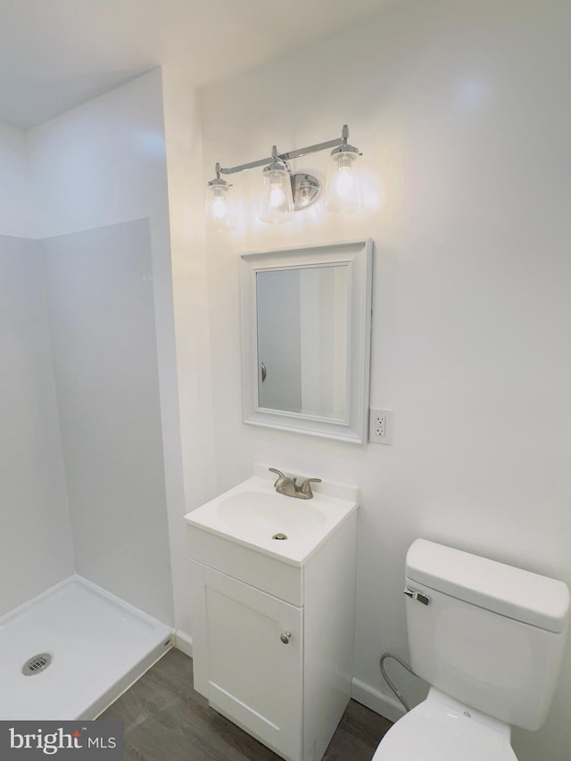 212 Logan St, Lewistown, PA 17044 - bathroom featuring vanity, toilet, wood-type flooring, and a shower
