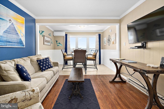 living room featuring a wall mounted air conditioner, hardwood / wood-style flooring, and ornamental molding