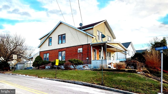 view of front of property with a porch and a front yard