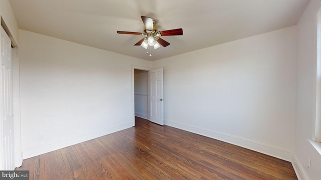 spare room featuring ceiling fan and dark hardwood / wood-style floors