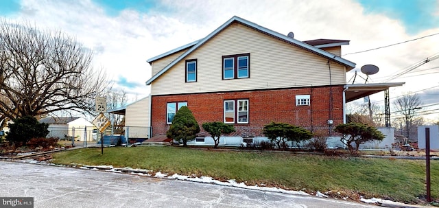 view of side of home featuring a lawn