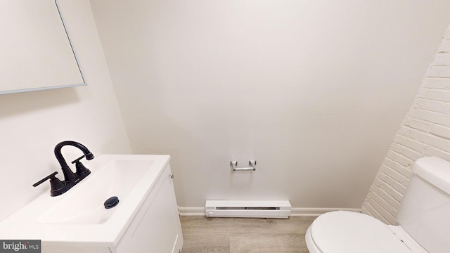 bathroom featuring a baseboard radiator, vanity, and toilet