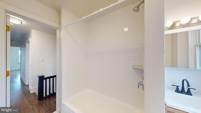 bathroom featuring tiled shower / bath combo, vanity, and hardwood / wood-style floors