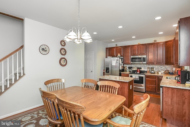 dining area featuring a notable chandelier and dark hardwood / wood-style flooring