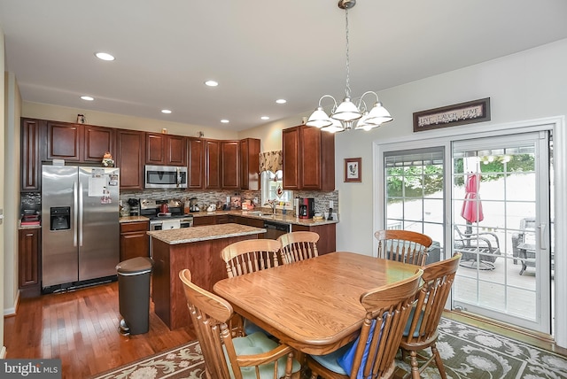 dining space with sink, a notable chandelier, and dark hardwood / wood-style flooring