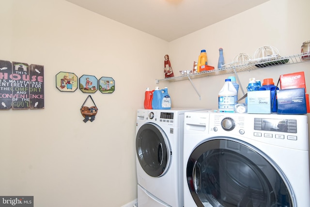 clothes washing area featuring washer and dryer