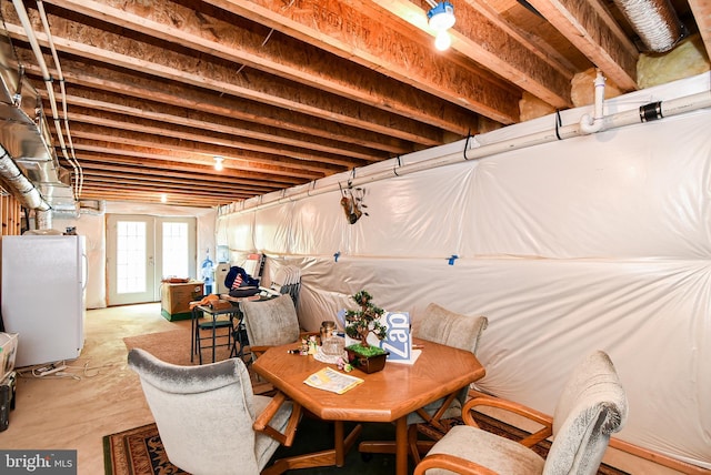 basement with french doors and white refrigerator