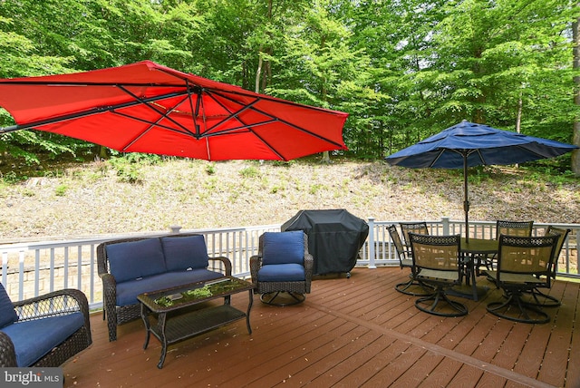 wooden deck featuring an outdoor living space and a grill