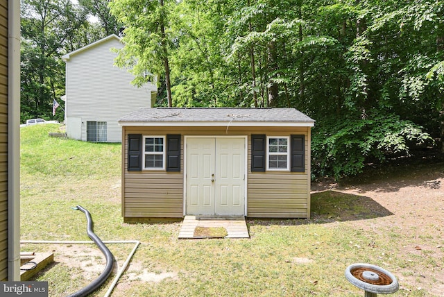 view of outbuilding featuring a lawn