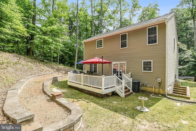 back of house featuring a wooden deck, a yard, and central AC