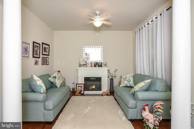 living room with dark wood-type flooring and ceiling fan