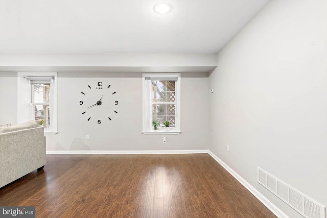 empty room featuring dark hardwood / wood-style flooring