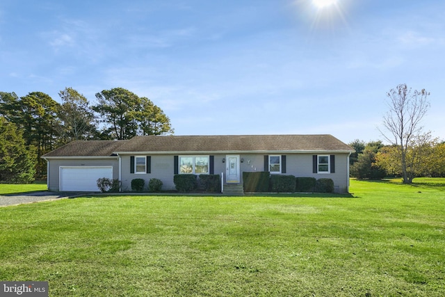 ranch-style house featuring a garage and a front lawn