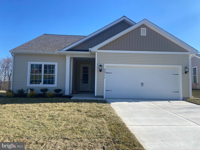 view of front facade with a garage and a front lawn