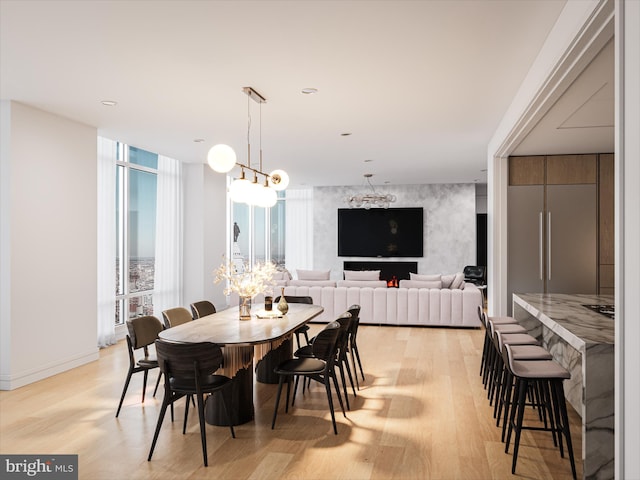 dining room with plenty of natural light and light hardwood / wood-style flooring