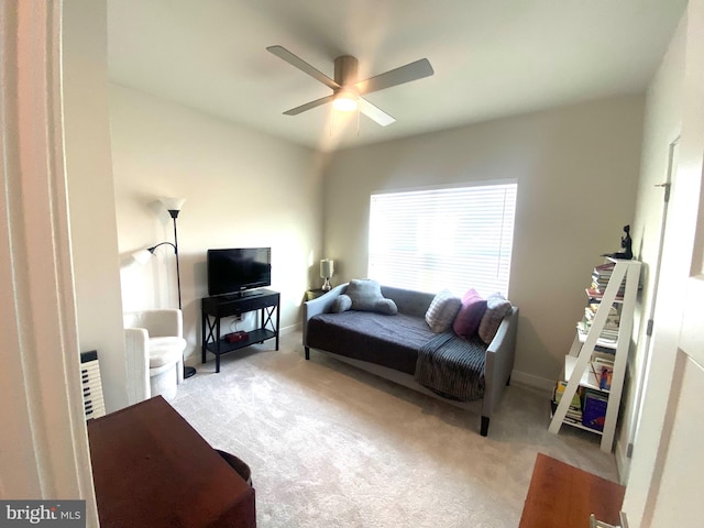 carpeted living room with ceiling fan