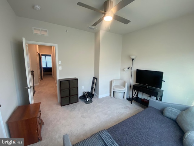 carpeted living room with ceiling fan