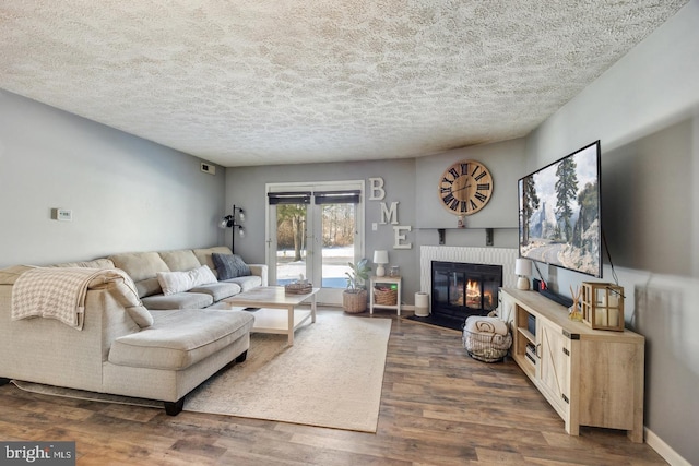 living room with dark hardwood / wood-style flooring and a textured ceiling