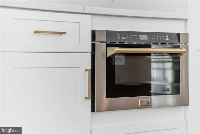 interior details with white cabinets and oven