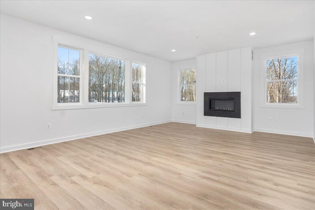 unfurnished living room featuring light hardwood / wood-style floors