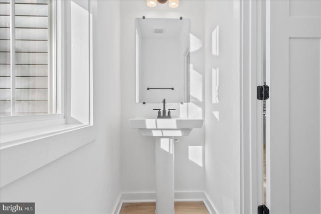 bathroom with hardwood / wood-style floors, sink, and a wealth of natural light